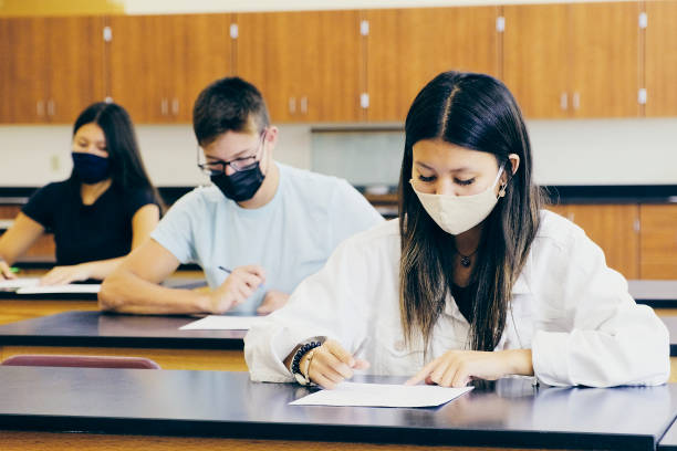 istock High School Students In Classroom Wearing Protective Face Mask 1264961129
