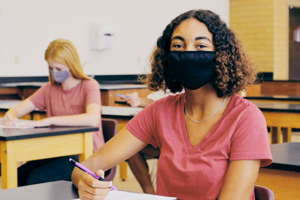 istock High School Students In Classroom Wearing Protective Face Mask 1264961860