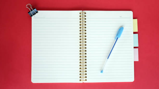 Open blank journal on red background. Concept for creative person planning. Back to school. Top view, flat lay, mockup Open blank journal on red background. Concept for creative person planning. Back to school. Top view, flat lay, mockup. bullet journal photos stock pictures, royalty-free photos & images