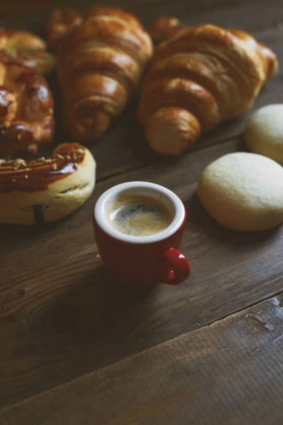 croissant, cake, espresso, macaron on wood