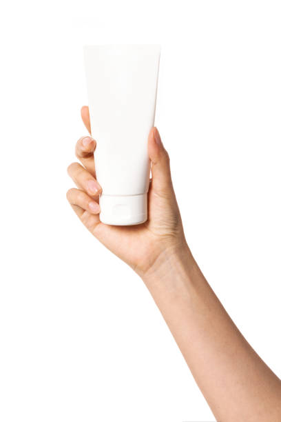 istock Woman hand hold a blank container isolated on white. 1264962167