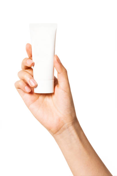 istock Woman hand hold a blank container isolated on white. 1264962171