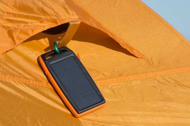 istock Charge your phone wirelessly with a solar panel. Equipment for camping and tourism. 1264964630