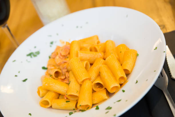 istock Rigatoni pasta with bacon, tomato and cream 1264964741