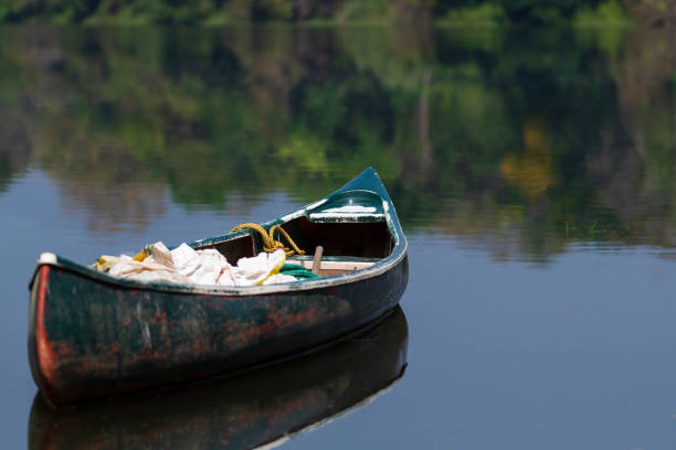 A boat or canoe in the still waters of the Periyar river in the south indian state of Kerala.