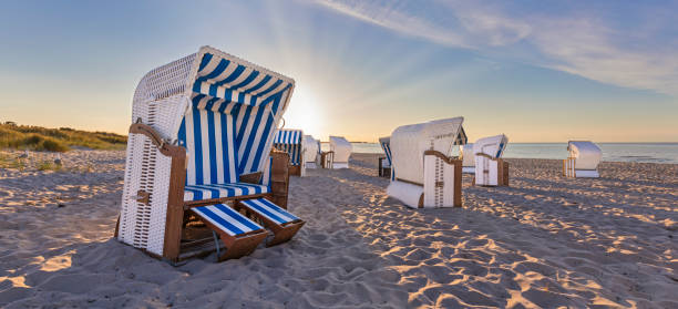 istock Canopied beach chairs at beach in evening light 1264966290