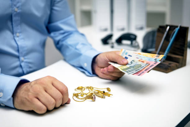 Man buying gold jewellry, pawn shop and euro banknotes Man buying gold jewellry, pawn shop and euro banknotes Gold karat stock pictures, royalty-free photos & images