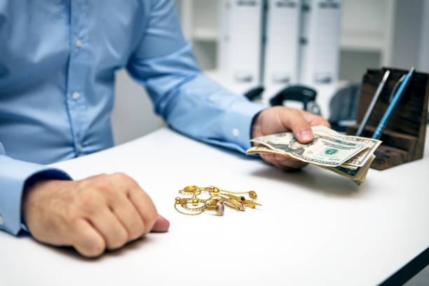 Man buying gold jewellry, pawn shop and us dollar banknotes Man buying gold jewellry, pawn shop and us dollar banknotes pawn chess piece photos stock pictures, royalty-free photos & images