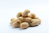 Closeup of heap of fresh peanuts on the white background