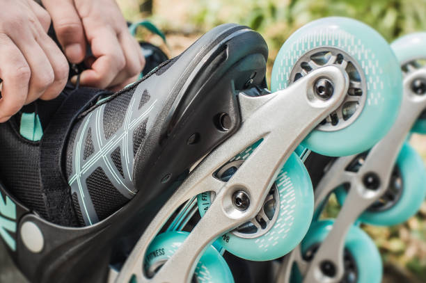 istock Woman putting on inline roller skates wheels in skatepark 1264967298