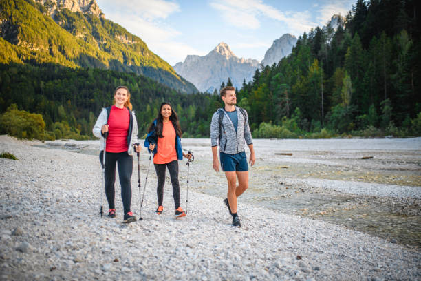 friends hiking along riverbed near jasna lake in slovenia - sport exercising men julian alps imagens e fotografias de stock