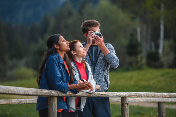 istock Hikers Pausing To Take Scenic Photo From Pedestrian Bridge 1264967732