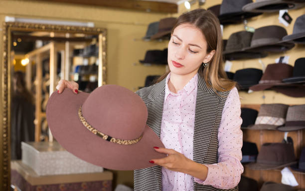 istock Woman choosing hat in store 1264969027