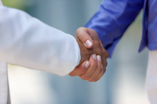 istock Businesswomen shaking hands 1264971800