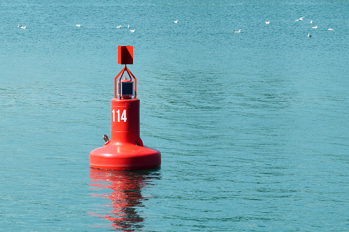 one red sea buoy close up on water