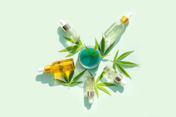 hemp cosmetic products glass bottles with oil,  seed extract and hemp  leaves on a mint background. Flat lay hemp cosmetic products glass bottles with oil,  seed extract and hemp  leaves on a mint background. Flat lay cannabidiol stock pictures, royalty-free photos & images