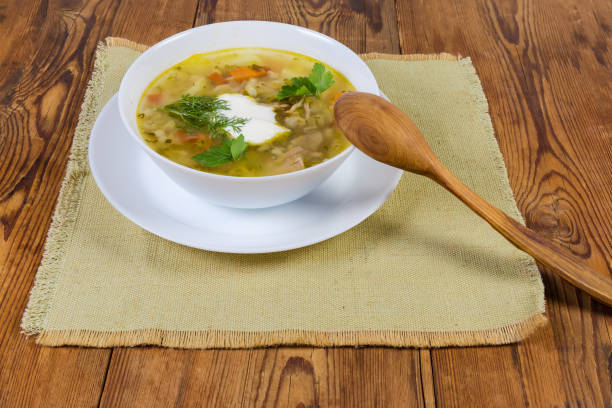 istock Rassolnik portion with wooden spoon on old rustic table 1264973070
