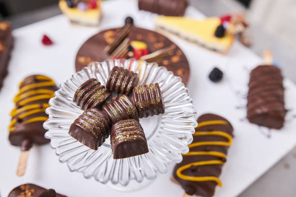 istock Lemon and chocolate cake surrounded with a cake popsicle and small desserts on a modern tray 1264974559