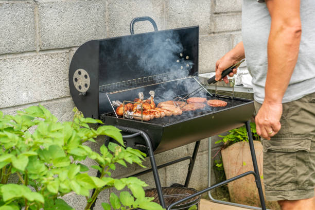istock Mature man cooking on backyard BBQ 1264975887