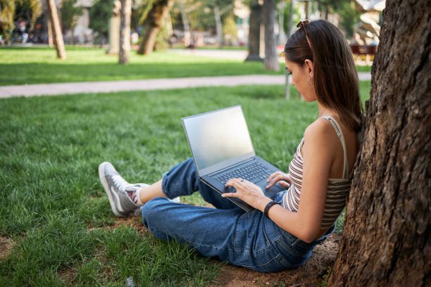 istock Female high school student working on her homework while enjoying fresh summer day at the public park 1264975935
