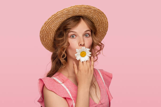 istock Funny lady with flower in mouth 1264976410