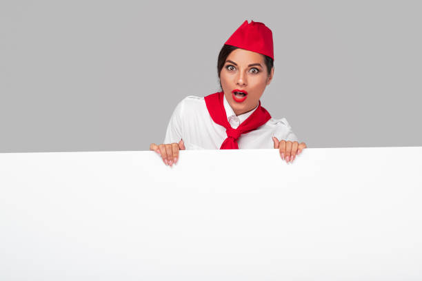 istock Shocked stewardess showing blank placard 1264976489