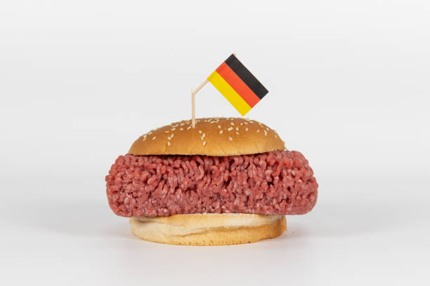 Hamburger with german flag Giant Hamburger with raw minced meat with a broken german flag sticking in it alternative for germany photos stock pictures, royalty-free photos & images