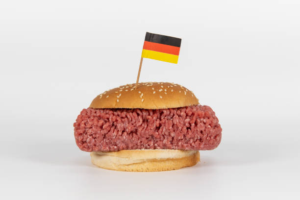 Hamburger with german flag Giant Hamburger with raw minced meat with a german flag sticking in it alternative for germany photos stock pictures, royalty-free photos & images