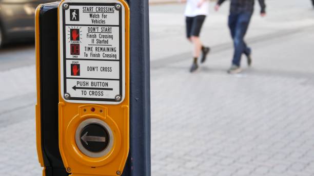 istock Traffic light button on pedestrian crosswalk, people have to push and wait. Traffic rules and regulations for public safety in USA. Zebra street crossing on road intesection in San Diego, California 1264980256