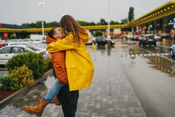 istock Romantic kiss in the rain 1264980382