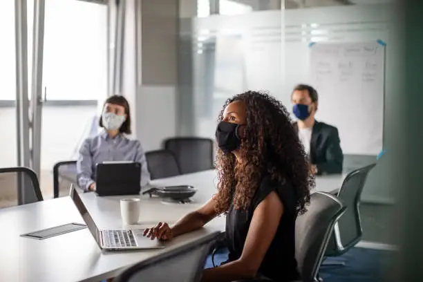 Photo of Business people having meeting during pandemic