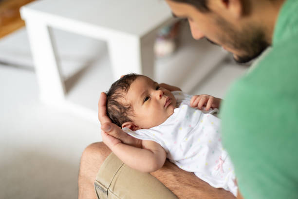 istock Father holding newborn baby 1264981236