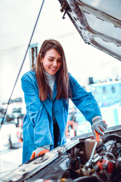 istock Smiling Female Mechanic Calibrating Engine Throttle 1264981270