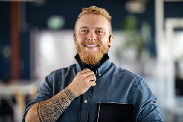istock Happy young business man with face mask 1264981376