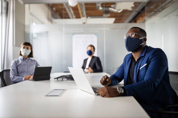 istock Business people having meeting during pandemic 1264981407