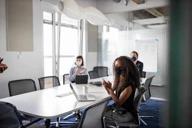 Photo of Group of business people clapping hands in the meeting room