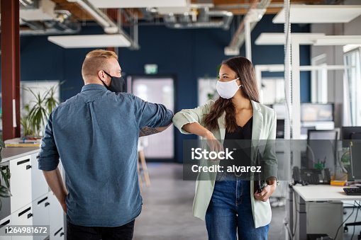 istock Business colleagues greeting with elbow in office 1264981672