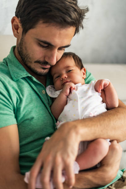 istock Father holding newborn baby 1264981723
