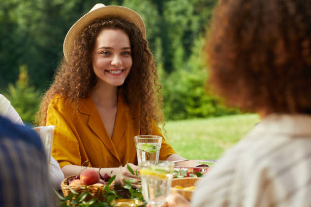 istock Smiling Young Woman Dining Outdoors 1264985335