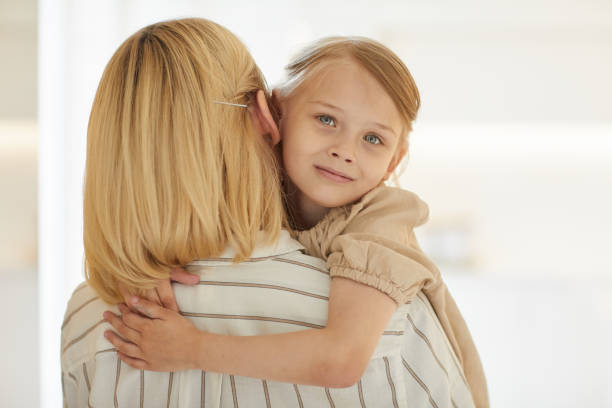 istock Cute Little Girl Embracing Mom 1264986357