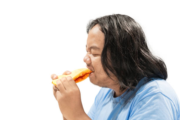 istock Asian man eating sandwich 1264986696