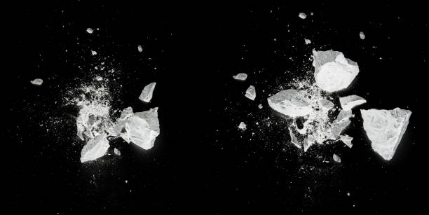 istock Splash, destroy, explosion by white pieces plaster, stone, chalk on black background 1264991513