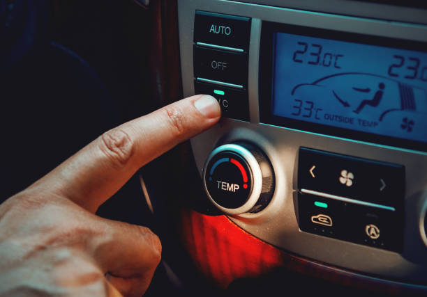 istock Man activating Air Conditioner in a modern car 1264992650