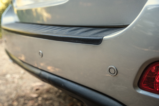 Close up of rear parking sensors of a luxury car