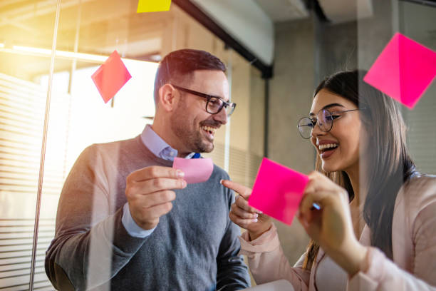 istock Young woman at work showing ideas to colleague 1264996469