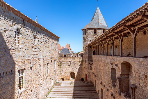 Carcassonne - France. July 5, 2020: Fortified wide walls and observation towers of the medieval castle of Carcassonne town