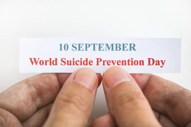 Person holding piece of paper with the words World Suicide Prevention Day (10 September) Person holding piece of paper with the words World Suicide Prevention Day (10 September). Close up. number 10 stock pictures, royalty-free photos & images