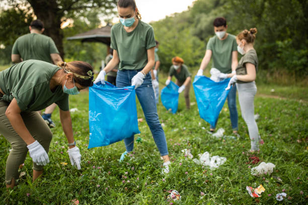 istock Volunteers cleaning public park together 1265004152
