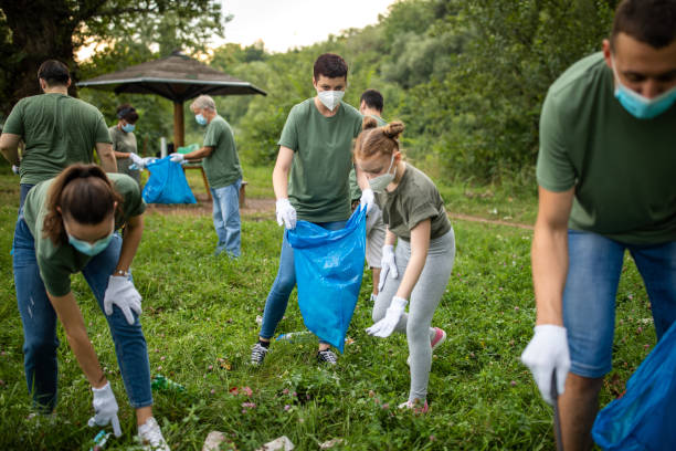 istock Environmental volunteers cleaning public park together 1265004200