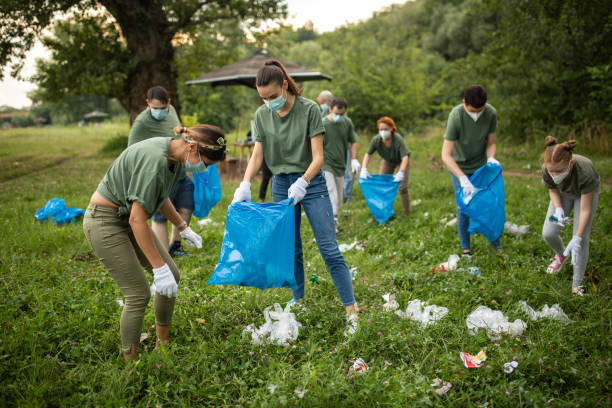 istock Volunteers picking up garbage together while cleaning public park 1265004231